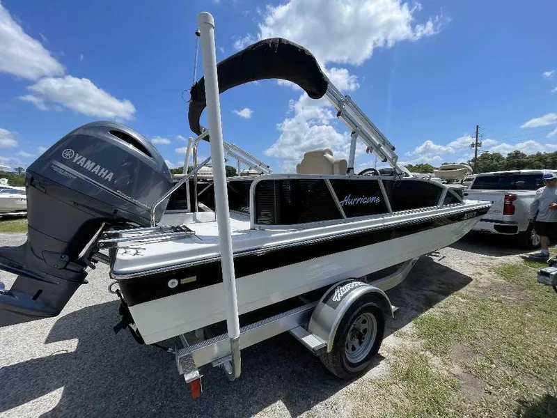 Slide: The Image of 2023 Hurricane Fundeck 198 Fish Package boat with Yamaha engine, parked outdoors. - 2