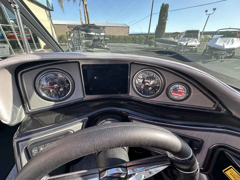 Slide: The Image of Dashboard of 2025 Sanger V215 SX boat with gauges and steering wheel. - 12