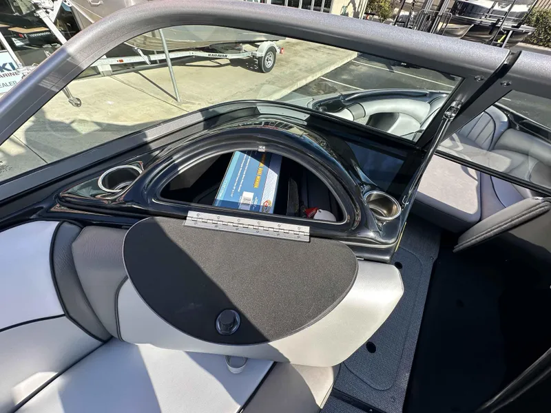 Slide: The Image of 2025 Sanger V215 SX boat interior with storage compartment and seating. - 14