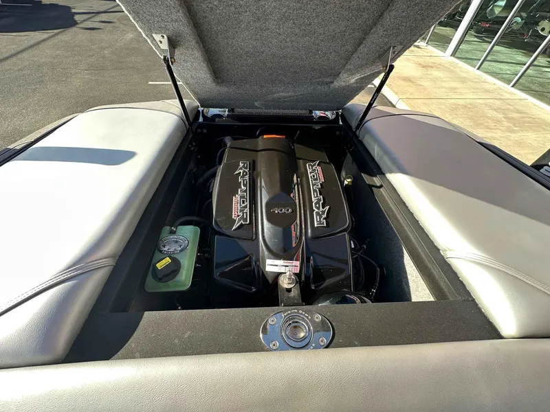 Slide: The Image of 2025 Sanger V215 SX boat engine compartment with Raptor motor, open hatch view. - 18