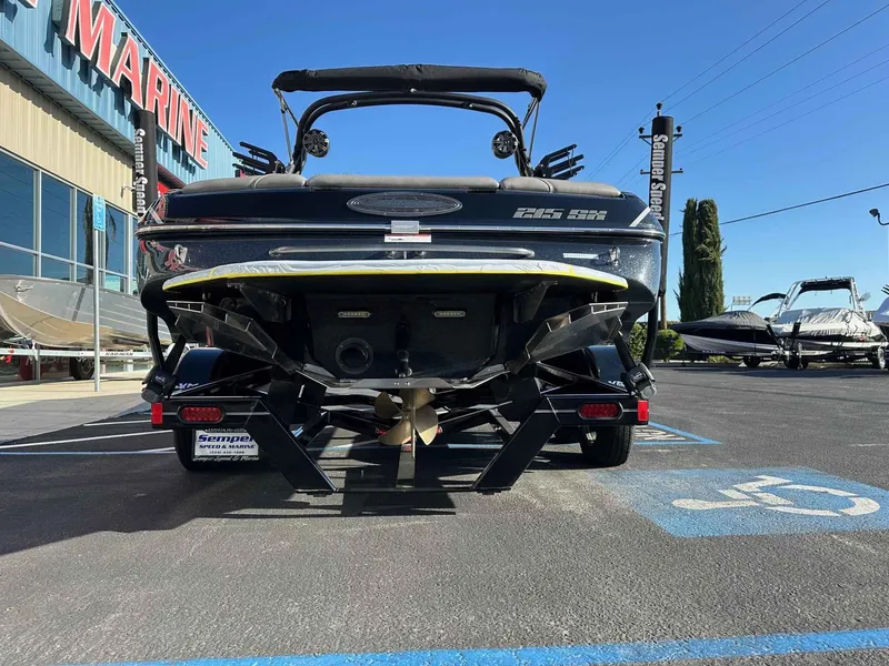 Slide: The Image of 2025 Sanger V215 SX boat rear view at a marine dealership. - 20