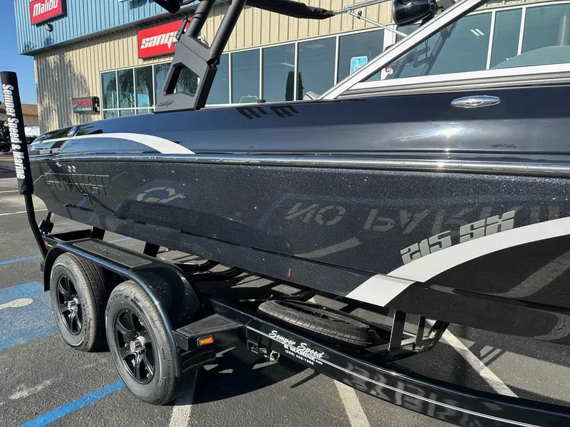 Slide: The Image of 2025 Sanger V215 SX boat on trailer, parked outside dealership. - 23