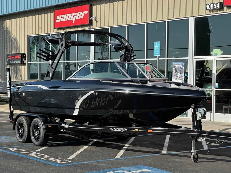 Slide: The Image of 2025 Sanger V215 SX boat on trailer outside dealership. - 3