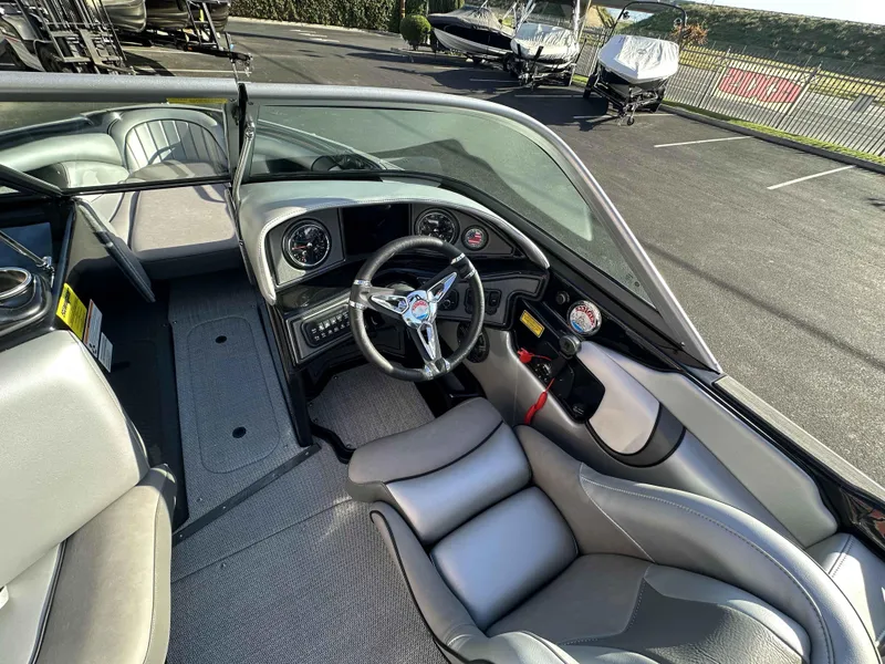Slide: The Image of Interior of 2025 Sanger V215 SX boat with sleek steering and modern dashboard. - 6