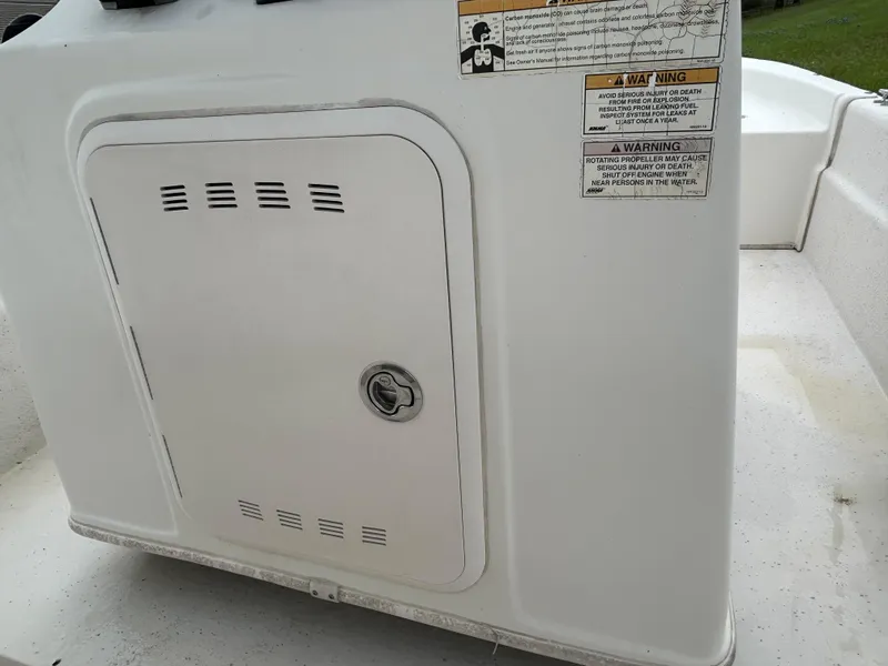 Slide: The Image of 2017 Carolina Skiff JVX Pre-Rig Series 18 boat compartment with warning labels. - 13