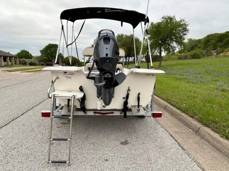 Slide: The Image of 2017 Carolina Skiff JVX Pre-Rig Series 18 boat with motor and ladder on a trailer. - 21
