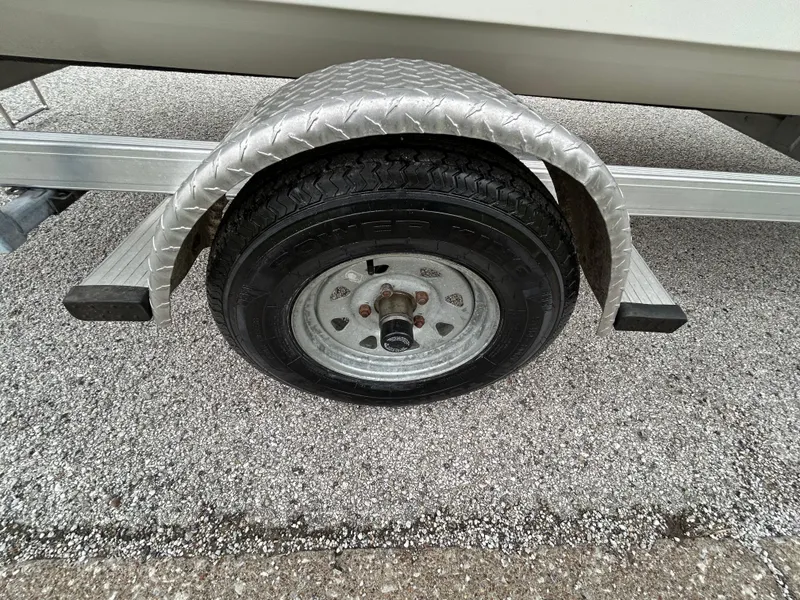 Slide: The Image of Trailer wheel of 2017 Carolina Skiff JVX Pre-Rig Series 18 on gravel surface. - 31