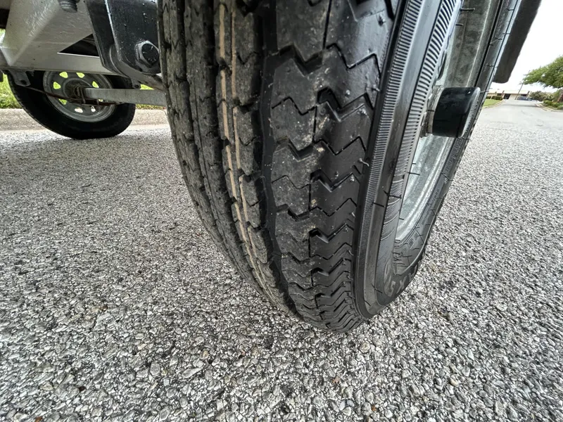 Slide: The Image of Close-up of a 2017 Carolina Skiff JVX Pre-Rig Series 18 trailer tire on asphalt. - 33