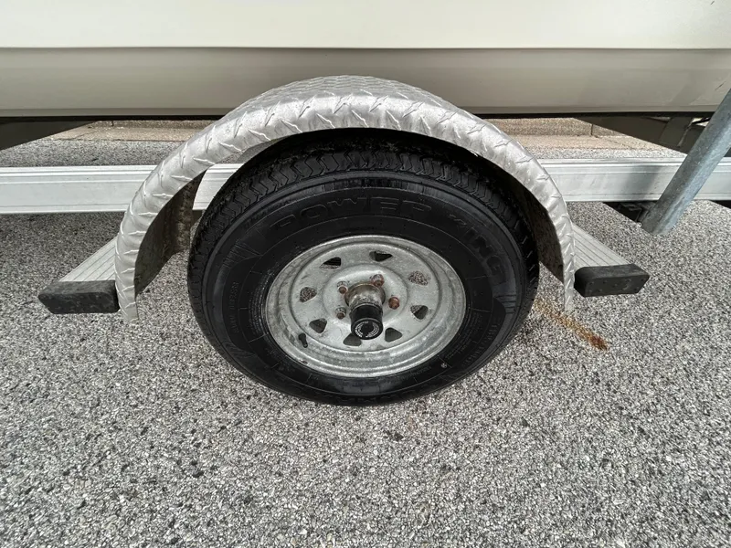 Slide: The Image of Trailer wheel of 2017 Carolina Skiff JVX Pre-Rig Series 18 on asphalt surface. - 34