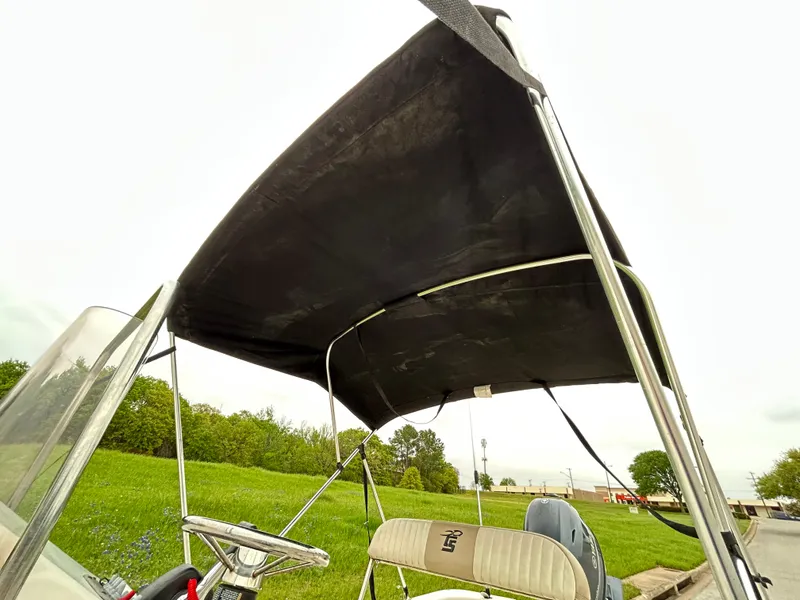 Slide: The Image of 2017 Carolina Skiff JVX Pre-Rig Series 18 with canopy, parked near grassy area. - 36