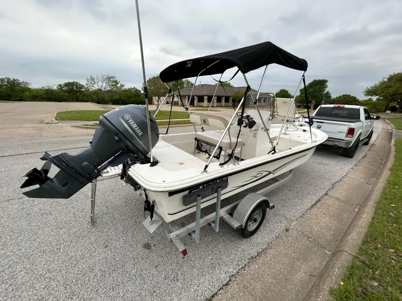 Slide: The Image of 2017 Carolina Skiff JVX Pre-Rig Series 18 boat on trailer, parked on street. - 45