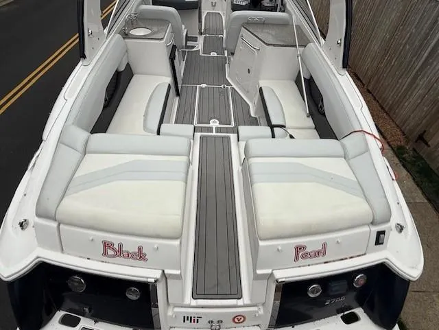 Slide: The Image of 2013 Regal 2700 Bowrider boat interior with white seating and gray flooring. - 11