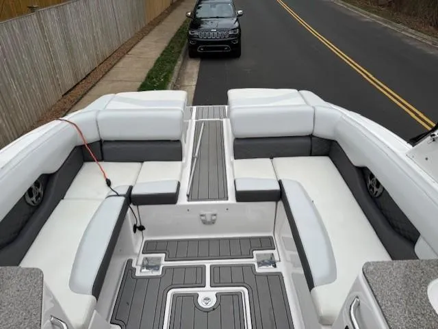 Slide: The Image of 2013 Regal 2700 Bowrider boat interior with white seating and gray flooring. - 14
