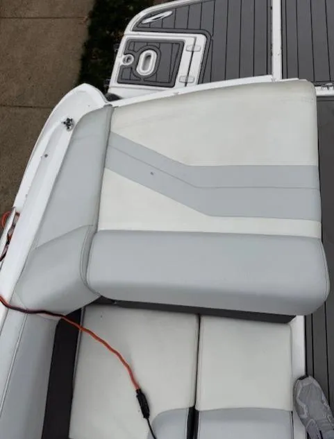 Slide: The Image of 2013 Regal 2700 Bowrider boat seat with gray and white upholstery. - 17