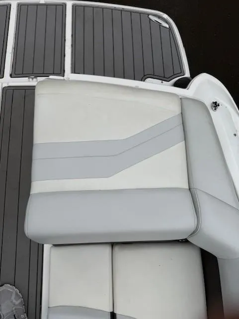 Slide: The Image of 2013 Regal 2700 Bowrider boat seat with gray and white upholstery. - 18