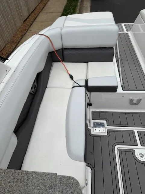 Slide: The Image of 2013 Regal 2700 Bowrider interior with white and gray seating and deck. - 20