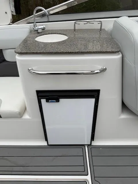 Slide: The Image of 2013 Regal 2700 Bowrider boat kitchenette with sink and mini fridge. - 21