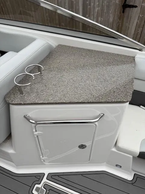 Slide: The Image of 2013 Regal 2700 Bowrider interior with countertop and storage compartment. - 23