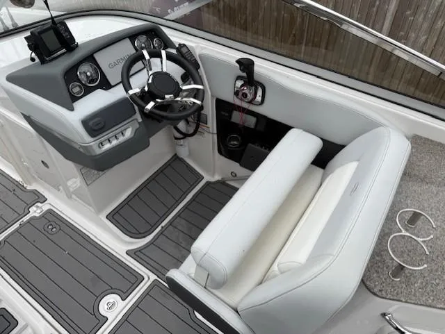 Slide: The Image of 2013 Regal 2700 Bowrider cockpit with steering wheel and seating, featuring modern controls. - 24