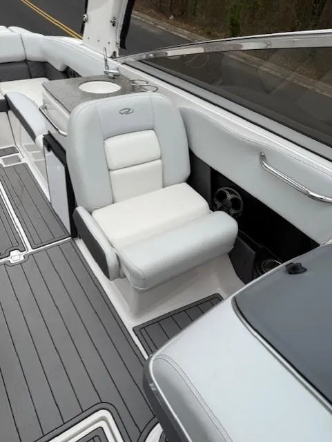Slide: The Image of 2013 Regal 2700 Bowrider interior with white seating and sleek design. - 25