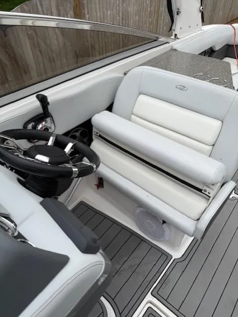Slide: The Image of 2013 Regal 2700 Bowrider interior with steering wheel and white seating. - 32