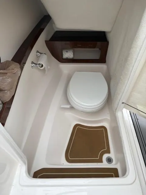 Slide: The Image of 2013 Regal 2700 Bowrider boat bathroom with toilet and sink. - 34
