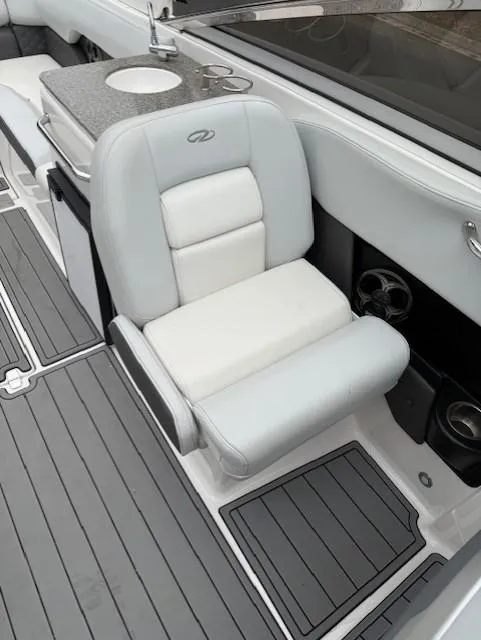 Slide: The Image of 2013 Regal 2700 Bowrider interior with white seating and sleek design. - 35