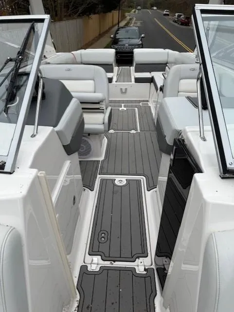 Slide: The Image of 2013 Regal 2700 Bowrider boat interior with gray flooring and white seating. - 37