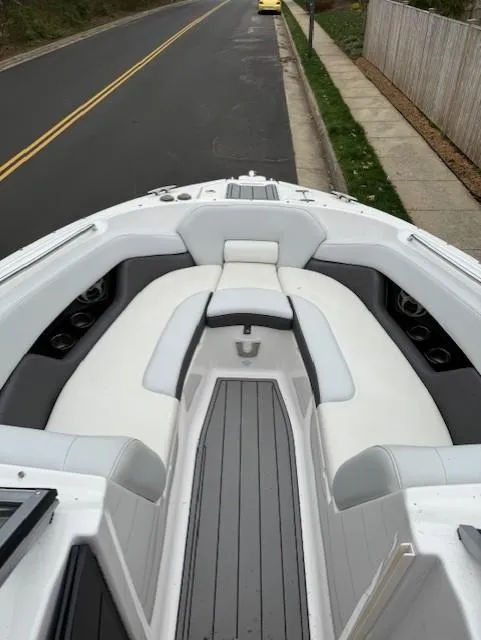 Slide: The Image of 2013 Regal 2700 Bowrider boat with spacious seating on a street. - 38