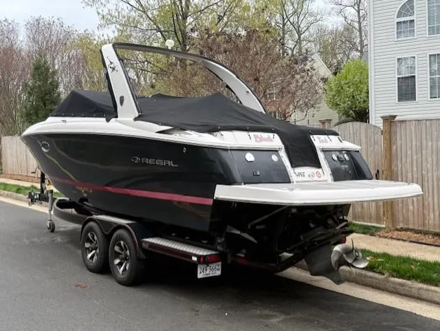 Slide: The Image of 2013 Regal 2700 Bowrider boat on trailer, parked on residential street. - 4