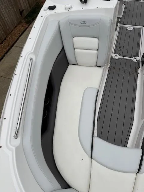 Slide: The Image of 2013 Regal 2700 Bowrider interior with white and gray seating and deck. - 40