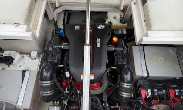 Slide: The Image of Engine compartment of a 2013 Regal 2700 Bowrider boat, showcasing the engine and components. - 42