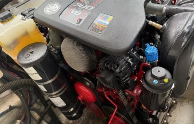 Slide: The Image of Engine of a 2013 Regal 2700 Bowrider boat, showcasing components and fluid reservoirs. - 43