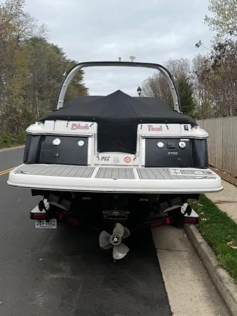Slide: The Image of 2013 Regal 2700 Bowrider boat parked on a street, rear view. - 5