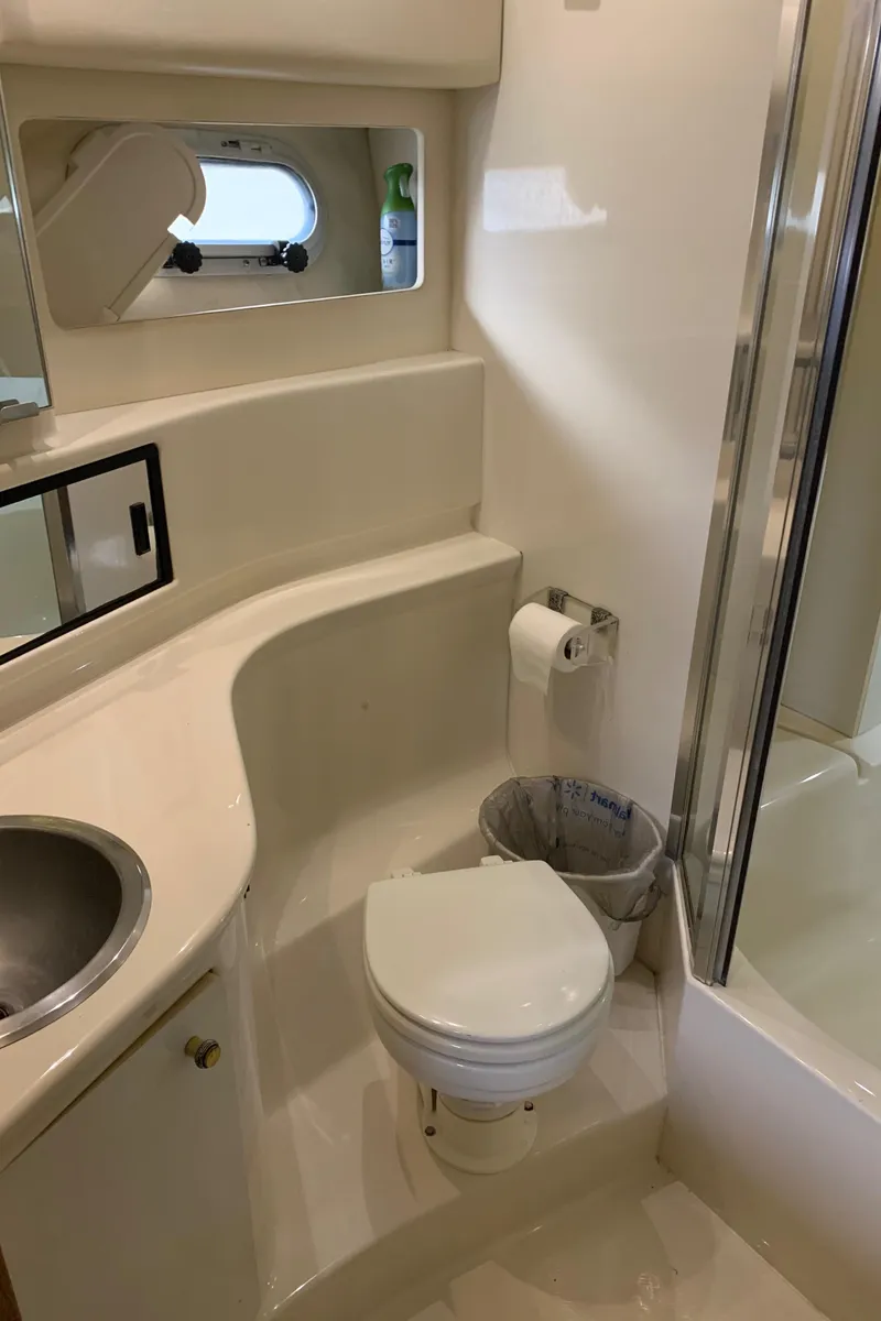 Slide: The Image of Bayliner 3988 2000 yacht bathroom with sink, toilet, and shower. - 19