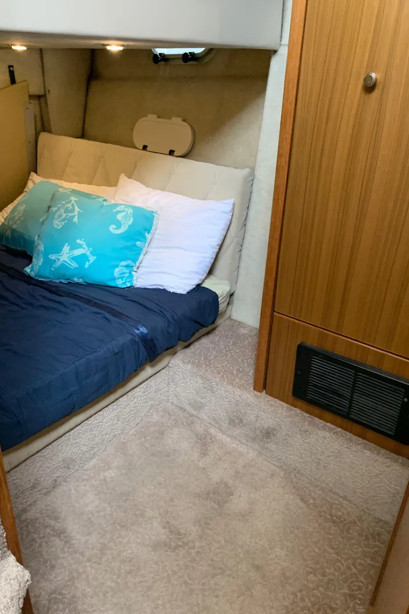 Slide: The Image of Cozy cabin interior of 2000 Bayliner 3988 with bed and wooden cabinetry. - 21