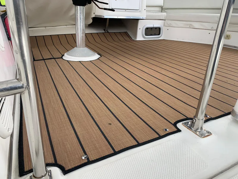 Slide: The Image of Bayliner 3988 2000 model boat deck with teak-style flooring and stainless steel railings. - 24