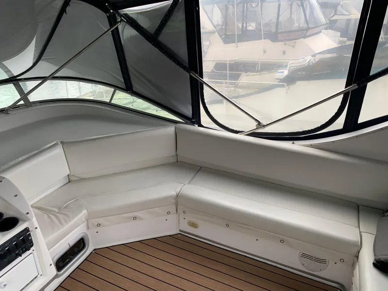 Slide: The Image of Bayliner 3988 yacht interior, 2000 model, featuring white seating and wooden flooring. - 25