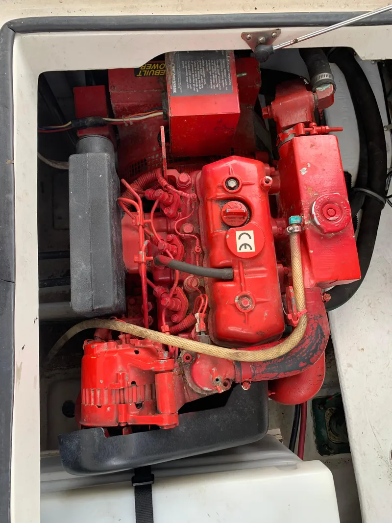 Slide: The Image of Engine compartment of a 2000 Bayliner 3988, featuring a red marine engine. - 27