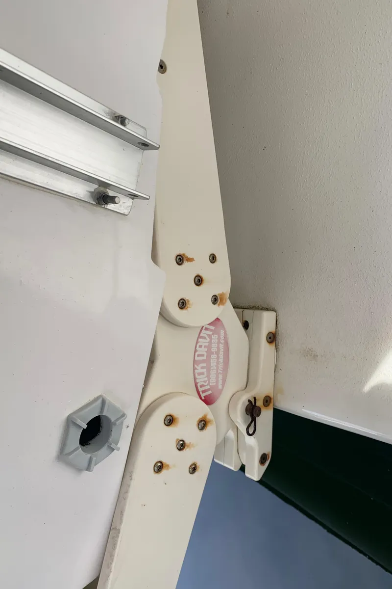 Slide: The Image of Bayliner 3988 2000 model boat hinge detail with visible screws and metal components. - 29