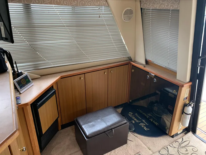 Slide: The Image of Interior of 2000 Bayliner 3988 yacht with wooden cabinets and blinds. - 3
