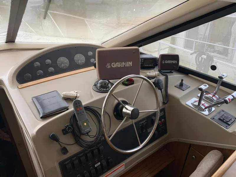 Slide: The Image of 2000 Bayliner 3988 helm with Garmin navigation, steering wheel, and control panel. - 5