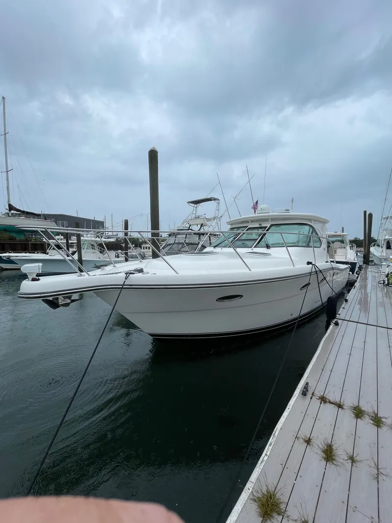 Slide: The Image of 2009 Tiara Yachts 32 Open docked at marina under cloudy sky. - 0