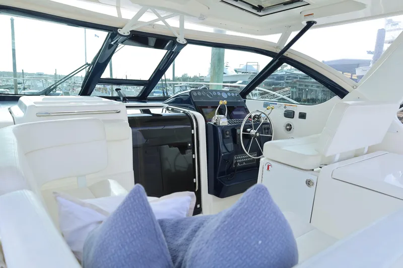 Slide: The Image of 2009 Tiara Yachts 32 Open interior with helm, white seating, and marina view. - 11