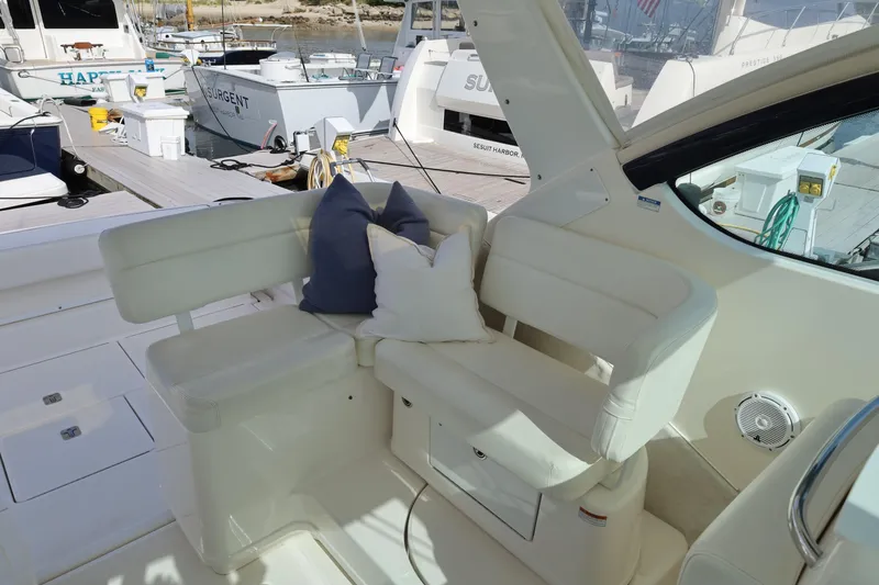 Slide: The Image of 2009 Tiara Yachts 32 Open interior with white seating and cushions at a marina. - 12