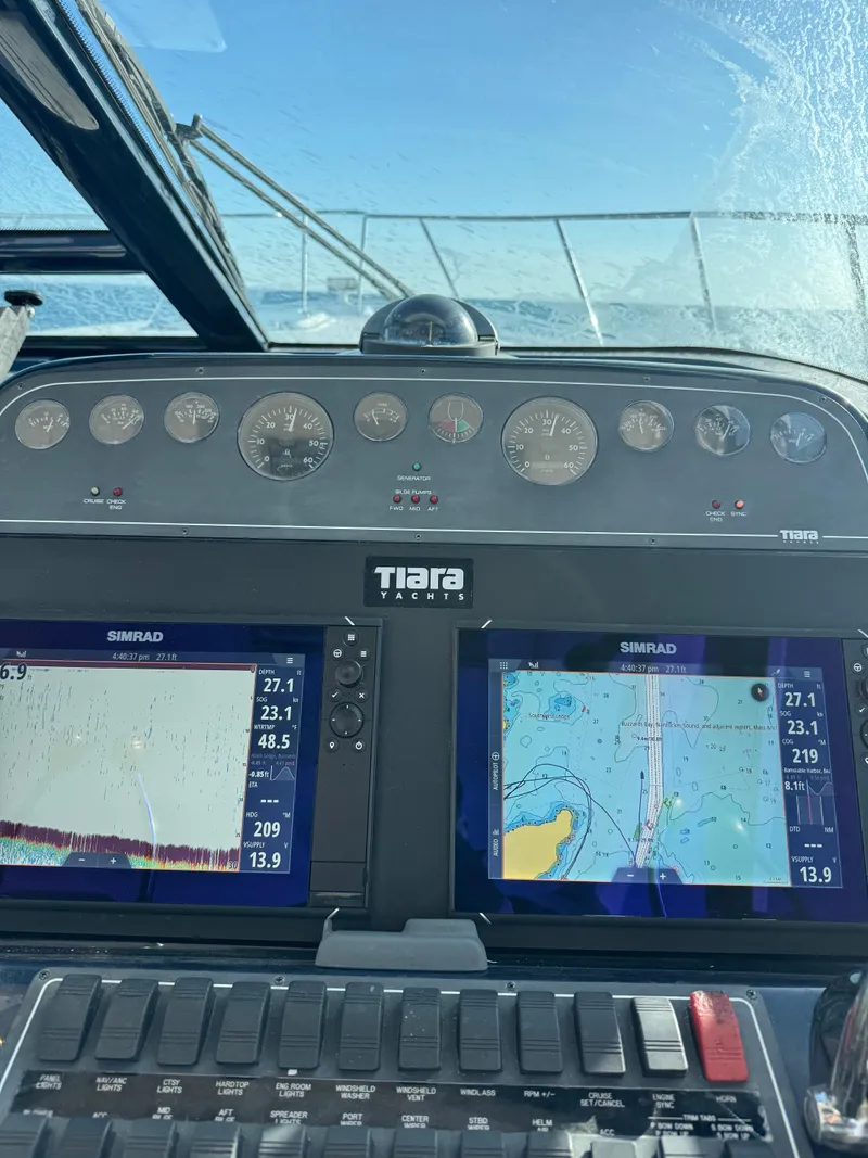 Slide: The Image of Dashboard of 2009 Tiara Yachts 32 Open with navigation screens and gauges. - 15