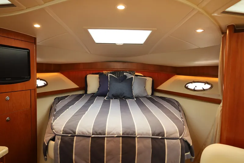 Slide: The Image of Luxurious cabin interior of 2009 Tiara Yachts 32 Open with cozy bed and ambient lighting. - 16