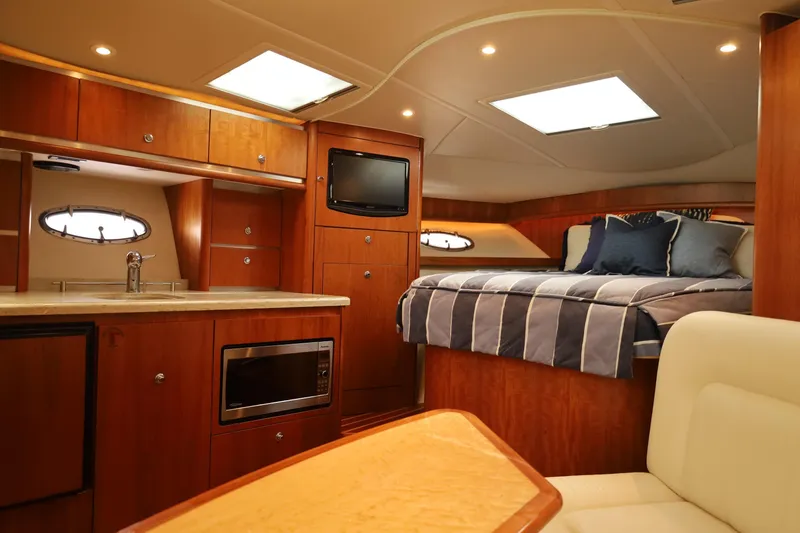 Slide: The Image of Luxurious interior of 2009 Tiara Yachts 32 Open, featuring a cozy bed and modern kitchenette. - 17