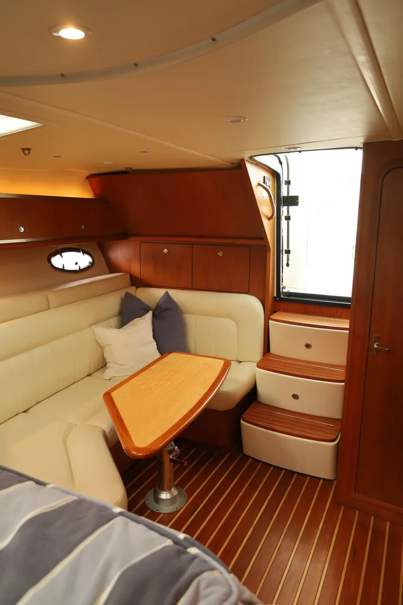 Slide: The Image of 2009 Tiara Yachts 32 Open interior with wood accents and cozy seating area. - 18