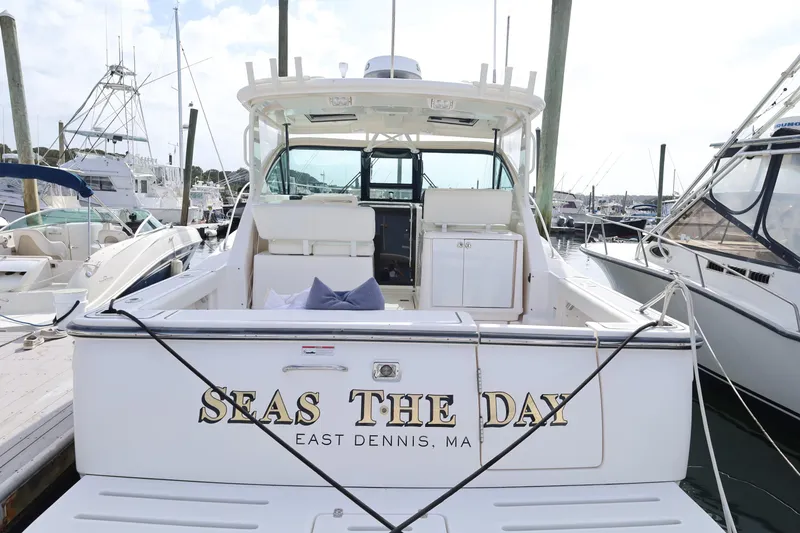 Slide: The Image of 2009 Tiara Yachts 32 Open docked, rear view with "Seas the Day" name visible. - 4